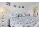 Relaxing bedroom with seashell bedding, white furniture and soft lighting at 4390 Exeter Dr # I305, Longboat Key, FL 34228