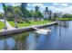 Community boat dock and lift in a landscaped waterfront community at 4390 Exeter Dr # I305, Longboat Key, FL 34228