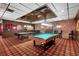 A large game room featuring pool tables, brick walls, and paneled lower walls at 4390 Exeter Dr # I305, Longboat Key, FL 34228