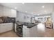 Modern kitchen opens to the living area with black countertops, white cabinets and stainless appliances at 4390 Exeter Dr # I305, Longboat Key, FL 34228