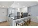 Bright kitchen features an island with a black countertop, barstool seating and mosaic tile backsplash at 4390 Exeter Dr # I305, Longboat Key, FL 34228