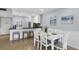 Kitchen featuring black countertops, white cabinets and an eat-in breakfast bar at 4390 Exeter Dr # I305, Longboat Key, FL 34228
