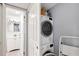 Efficient laundry area with stacked washer and dryer, and storage space perfect for a streamlined home at 4390 Exeter Dr # I305, Longboat Key, FL 34228