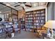 Charming library with floor to ceiling bookshelves, comfortable seating, and a ceiling fan at 4390 Exeter Dr # I305, Longboat Key, FL 34228