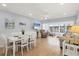 Open-concept living and dining area featuring light-filled windows and comfortable seating at 4390 Exeter Dr # I305, Longboat Key, FL 34228