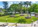 Community picnic area with tables in a grassy and landscaped waterfront area at 4390 Exeter Dr # I305, Longboat Key, FL 34228