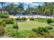 Community putting green surrounded by tropical landscaping and pool area at 4390 Exeter Dr # I305, Longboat Key, FL 34228