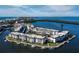 Aerial view of a waterfront condo community that offers boat slips on a sunny day with blue skies at 4400 Exeter Dr # J-201, Longboat Key, FL 34228