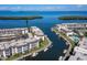 Aerial view of waterfront condos featuring boat docks, and a community pool with access to open water and beach at 4400 Exeter Dr # J-201, Longboat Key, FL 34228