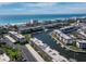 Aerial view of waterfront property with a community pool and boat docks offering luxurious coastal living at 4400 Exeter Dr # J-201, Longboat Key, FL 34228