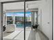 Bright balcony with tile floors overlooks the water and community buildings with boats in the water at 4400 Exeter Dr # J-201, Longboat Key, FL 34228