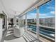 Enclosed sunroom with tile floors, balcony access with a view of pool and community buildings at 4400 Exeter Dr # J-201, Longboat Key, FL 34228