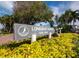 A welcoming Longboat Harbour sign nestled among colorful flowers and lush greenery in a well maintained community at 4400 Exeter Dr # J-201, Longboat Key, FL 34228