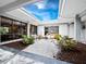 A serene courtyard with a lovely water fountain feature, beautiful landscaping, and tranquil seating at Longboat Harbour at 4400 Exeter Dr # J-201, Longboat Key, FL 34228