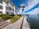 Waterfront condominium complex featuring a private dock and walkway along the canal with access to open water at 4400 Exeter Dr # J-201, Longboat Key, FL 34228