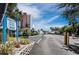Condo entrance sign with building, parking, palms and blue skies at Longboat Harbour, Longboat Key at 4400 Exeter Dr # J-201, Longboat Key, FL 34228