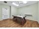 Community game room with wood-look flooring offers an air hockey table and bright lighting at 4400 Exeter Dr # J-201, Longboat Key, FL 34228