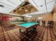 Community game room showcases billiard tables, dark wooden accents, red carpeting, and ample lighting at 4400 Exeter Dr # J-201, Longboat Key, FL 34228