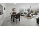 Open-concept living and dining area with tile floors and ample natural light at 4400 Exeter Dr # J-201, Longboat Key, FL 34228