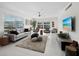 Bright living room featuring neutral colors, tile flooring, and a view of the surrounding area at 4400 Exeter Dr # J-201, Longboat Key, FL 34228