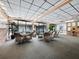 Bright lounge area features ample seating, carpet flooring, many windows and a decorative fountain at 4400 Exeter Dr # J-201, Longboat Key, FL 34228