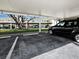 Parking area with multiple parking spaces for tenants and greenery at 4400 Exeter Dr # J-201, Longboat Key, FL 34228