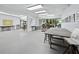 Bright studio space with concrete flooring, gallery lighting, multiple work tables, and large glass sliding doors at 4400 Exeter Dr # J-201, Longboat Key, FL 34228