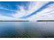 Expansive water view showing calm waters stretching to the horizon under a partly cloudy blue sky at 4400 Exeter Dr # J-201, Longboat Key, FL 34228