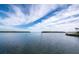 Picturesque water view with calm waters and distant land under a partly cloudy blue sky, ideal for boating and relaxation at 4400 Exeter Dr # J-201, Longboat Key, FL 34228