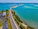 A stunning aerial view of a scenic road with palm trees near the ocean at 460 S Paula Dr # 304, Dunedin, FL 34698