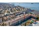 Property aerial view showcasing the building's layout, parking, landscaping, proximity to the water at 460 S Paula Dr # 304, Dunedin, FL 34698