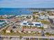 Aerial view of building near the water and the location with a community pool and waterfront views at 460 S Paula Dr # 304, Dunedin, FL 34698
