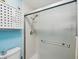 Clean and bright bathroom with white vanity, toilet and a modern shower at 460 S Paula Dr # 304, Dunedin, FL 34698