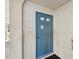 Clubhouse door with blue paint, metal hardware, and signage at 460 S Paula Dr # 304, Dunedin, FL 34698