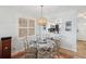 Bright dining area featuring a decorative chandelier and a view of the kitchen at 460 S Paula Dr # 304, Dunedin, FL 34698