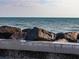A serene ocean view of a rock wall leading to the ocean at 460 S Paula Dr # 304, Dunedin, FL 34698