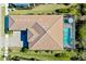 Aerial view showcases the house, roof, and the pool with its enclosure from an elevated perspective at 4609 Antrim Dr, Sarasota, FL 34240