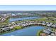 Aerial view of a residential community featuring waterfront homes situated alongside a picturesque lake at 4609 Antrim Dr, Sarasota, FL 34240