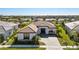 Aerial shot of a well-manicured single-story home that is close to the lake, with a paver driveway at 4609 Antrim Dr, Sarasota, FL 34240