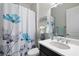 Bathroom featuring a single vanity, modern faucet, and shower with patterned curtain at 4609 Antrim Dr, Sarasota, FL 34240