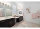 Bright bathroom featuring double vanity, shower, and modern lighting at 4609 Antrim Dr, Sarasota, FL 34240
