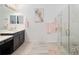 Well-lit bathroom with glass shower, modern vanity, and neutral and pink accents at 4609 Antrim Dr, Sarasota, FL 34240