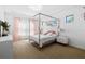 Stylish bedroom featuring a four-poster bed, pink accents, and modern decor at 4609 Antrim Dr, Sarasota, FL 34240