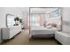 Cozy bedroom featuring neutral carpeting, a four poster bed, and natural light at 4609 Antrim Dr, Sarasota, FL 34240