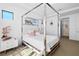 Beautiful bedroom with a four poster bed, white furniture, and neutral carpet flooring at 4609 Antrim Dr, Sarasota, FL 34240