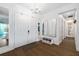 Bright foyer features double front doors, adjacent mirrors, bench seating and hardwood flooring at 4609 Antrim Dr, Sarasota, FL 34240