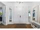 Bright foyer features double front doors, adjacent mirrors, bench seating and hardwood flooring at 4609 Antrim Dr, Sarasota, FL 34240