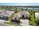 Beautiful property with a tile roof, pristine landscaping, and a serene lake view in the distance at 4609 Antrim Dr, Sarasota, FL 34240