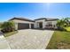Beautiful single-story home with a stone driveway, lush landscaping and a two-car garage at 4609 Antrim Dr, Sarasota, FL 34240
