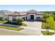 Exterior elevation showcasing the home with a well-manicured front yard and a brick driveway at 4609 Antrim Dr, Sarasota, FL 34240